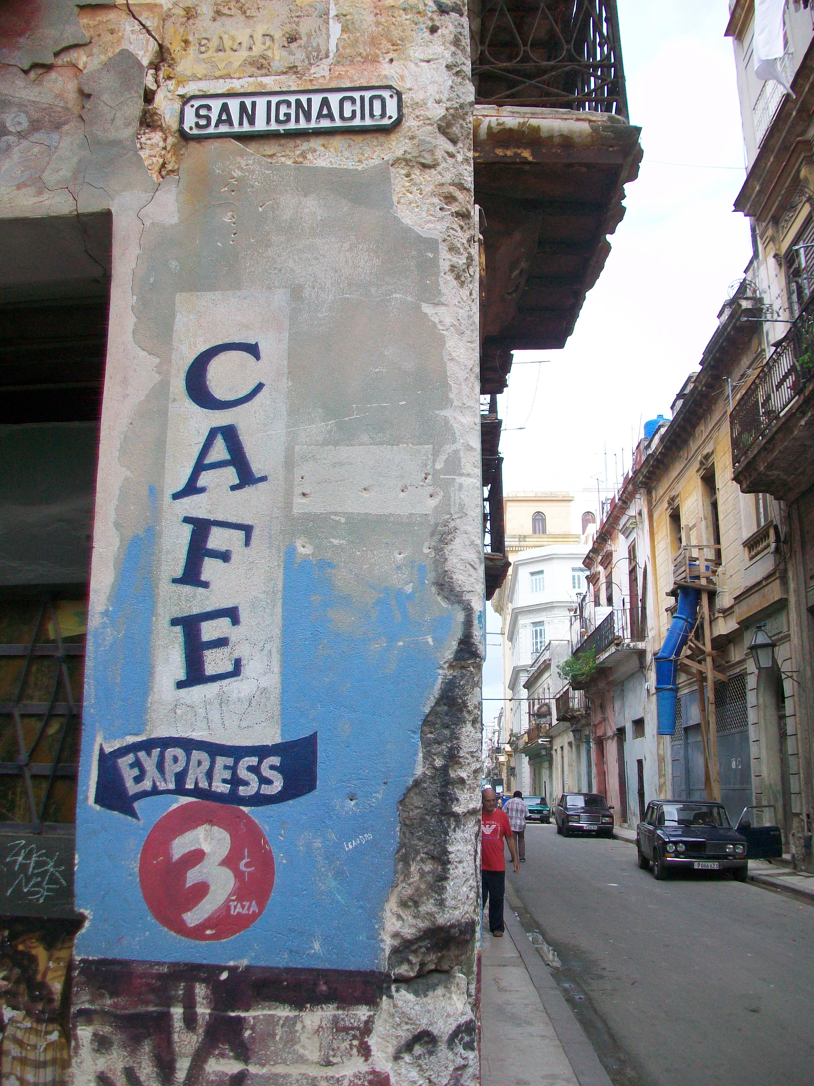 Weathered Café Express sign on the corner of a narrow city street